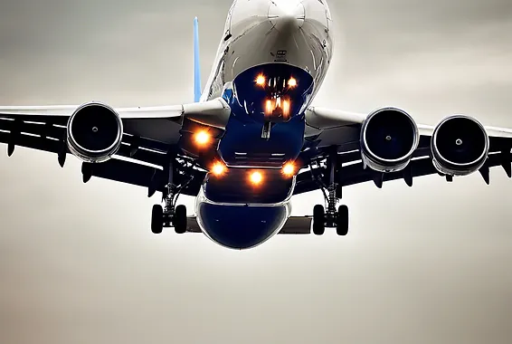 Airplane approaching for landing with lights on